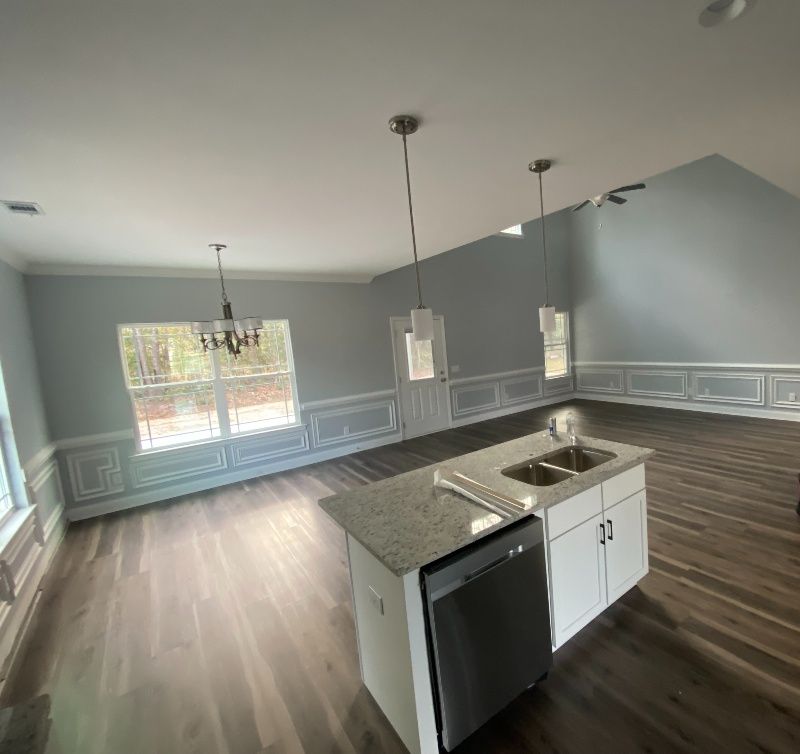 A kitchen with a sink and a dishwasher in a house.
