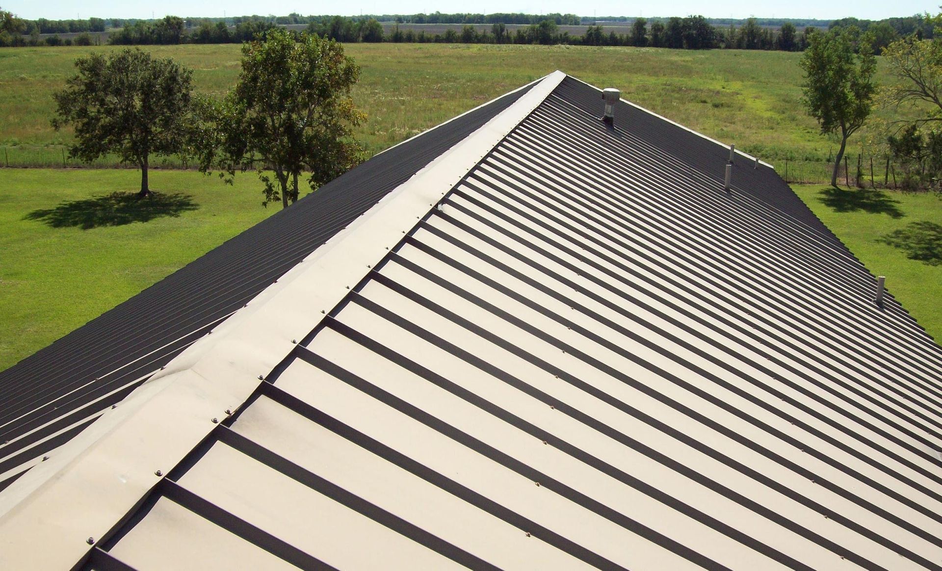 an aerial view of a roof with trees in the background