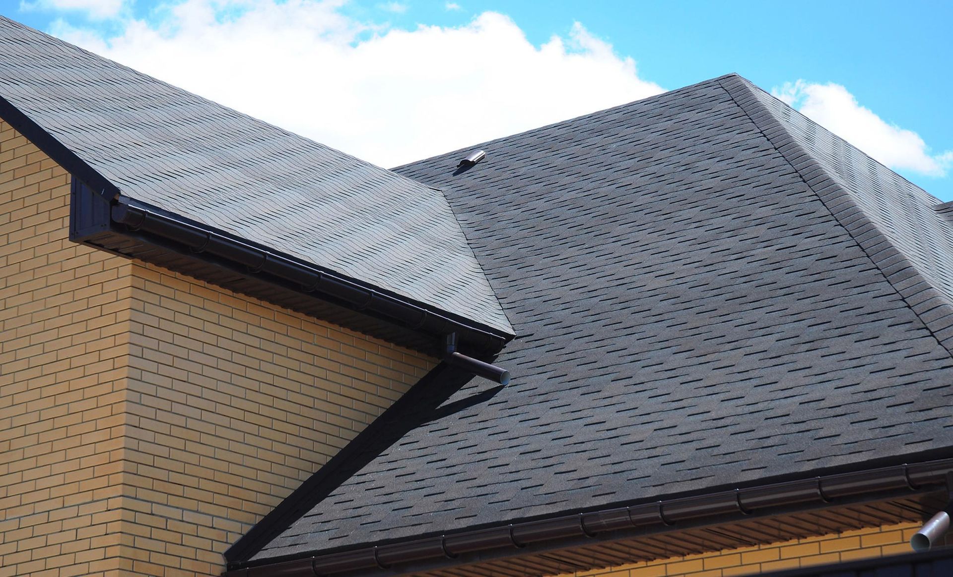a close up of a roof of a house with a blue sky in the background .
