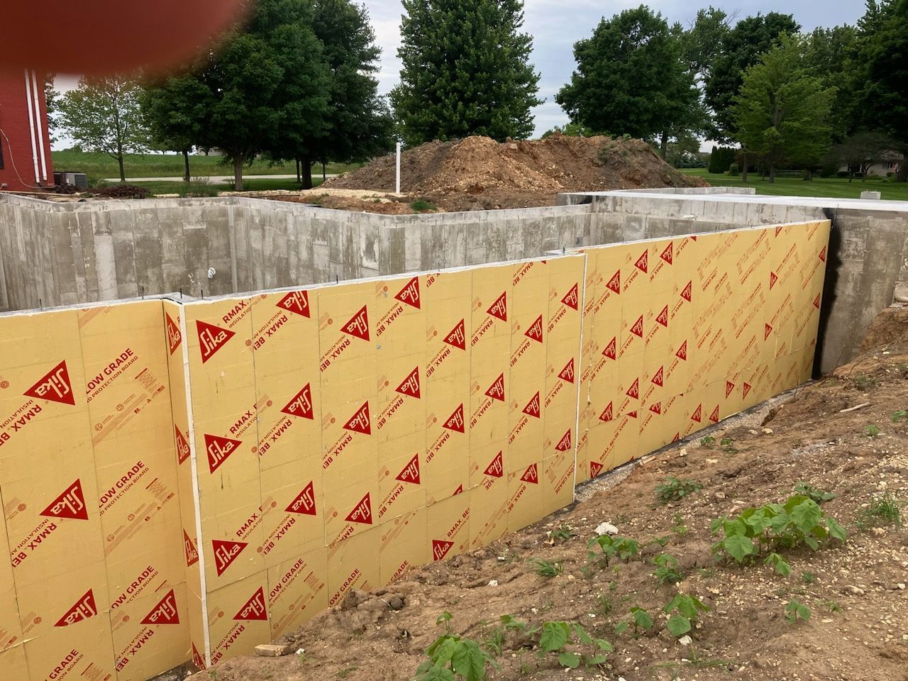 A concrete wall is being built with acrylic sheets.