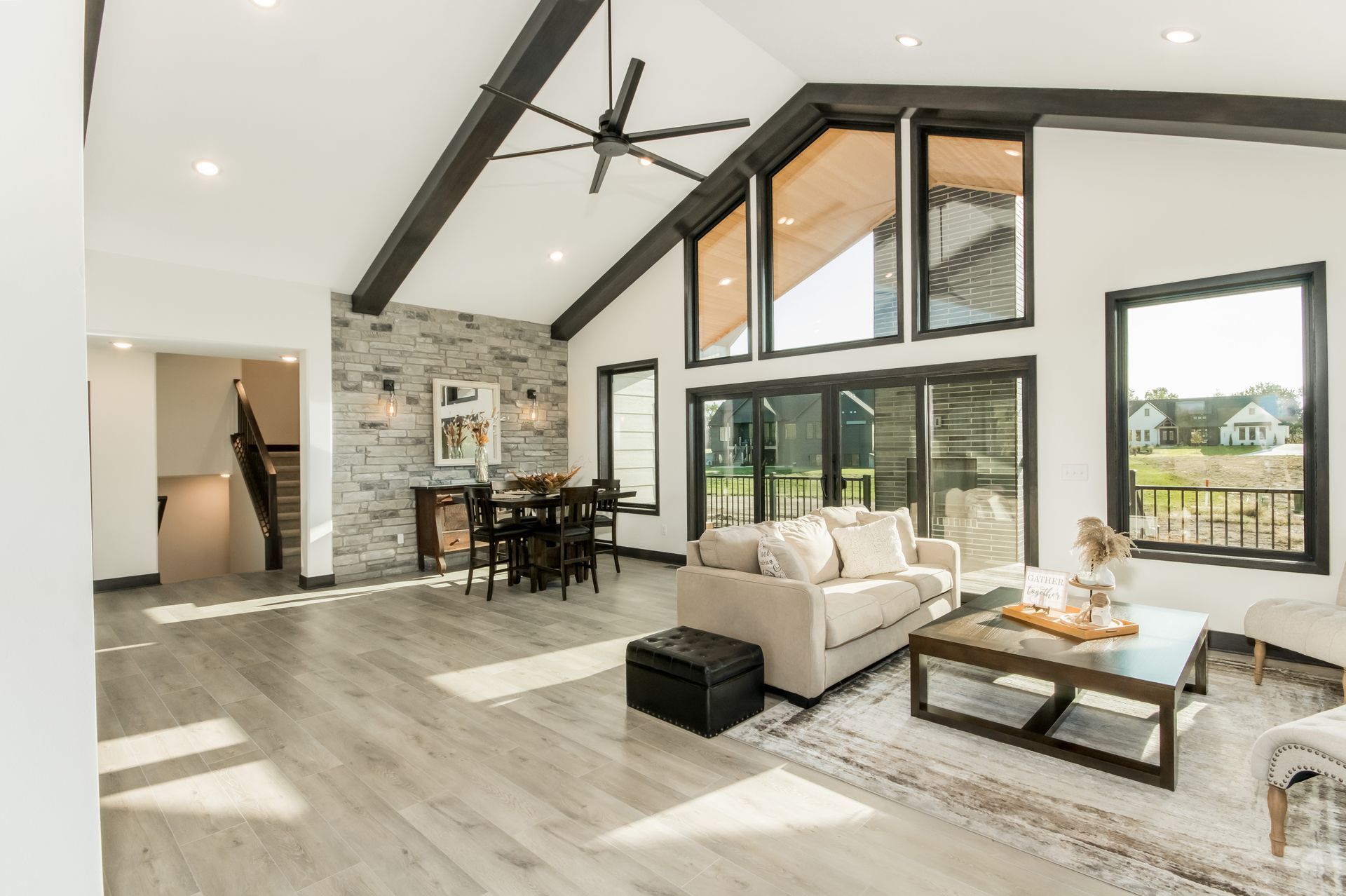 A living room filled with furniture and a ceiling fan.