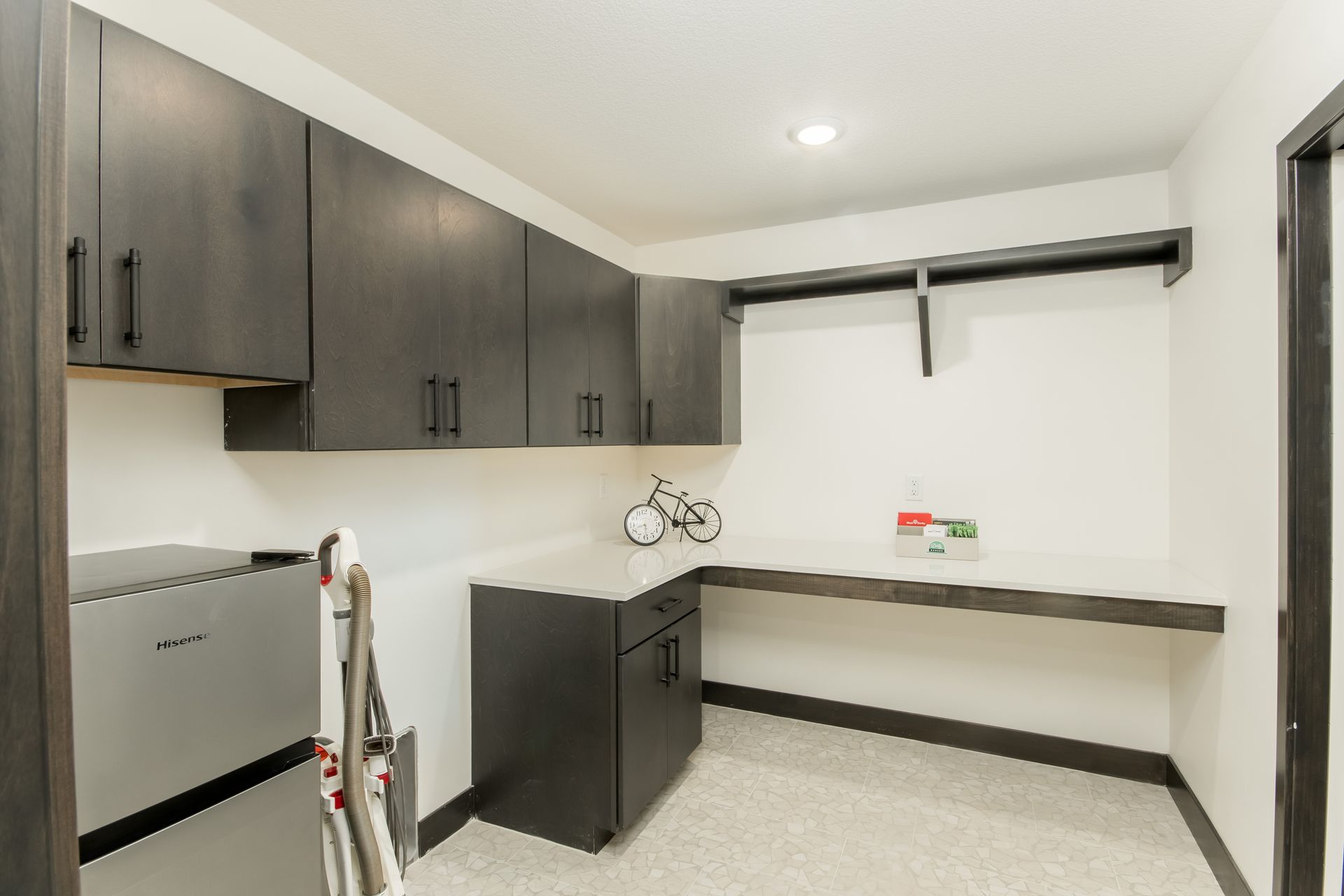 A laundry room with a ladder and a bicycle on the counter.
