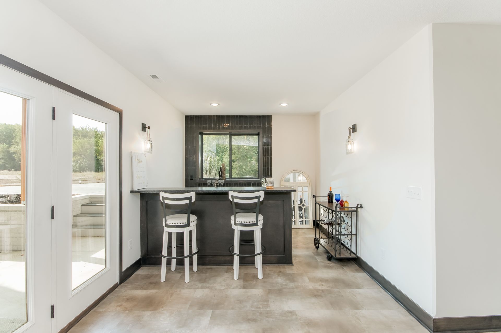 A kitchen with a bar and stools in it.