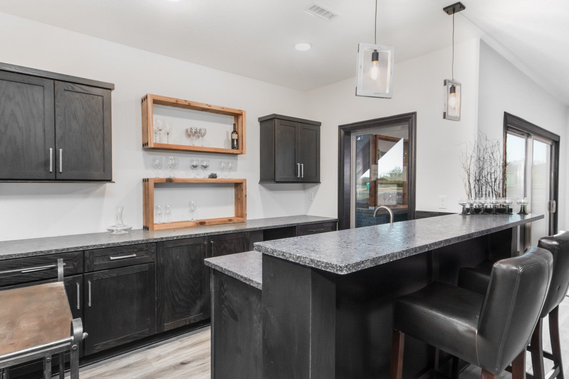 A kitchen with a large island and stools.