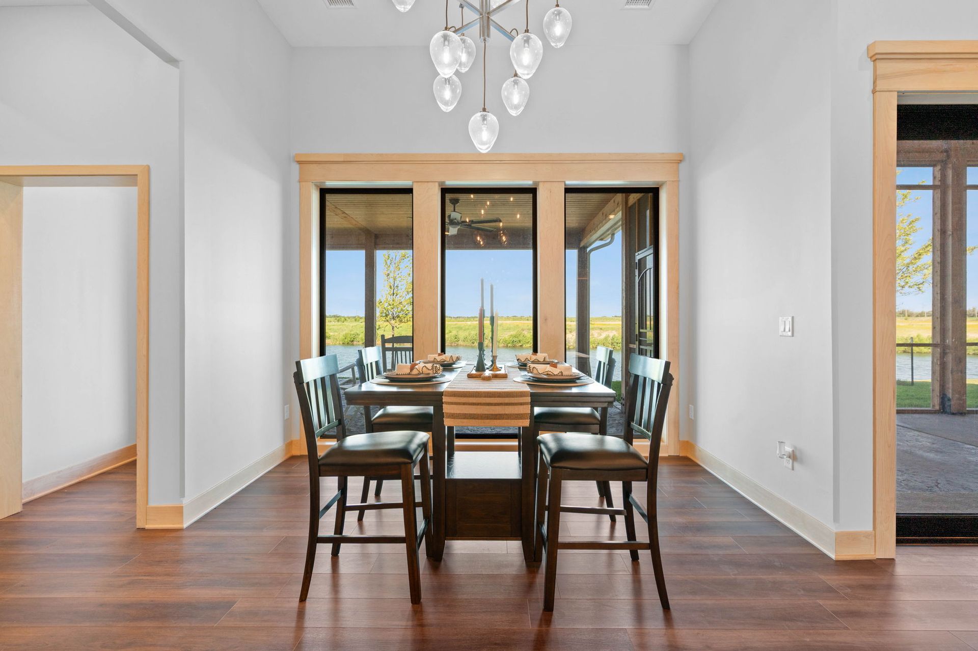A dining room with a table and chairs and a chandelier.