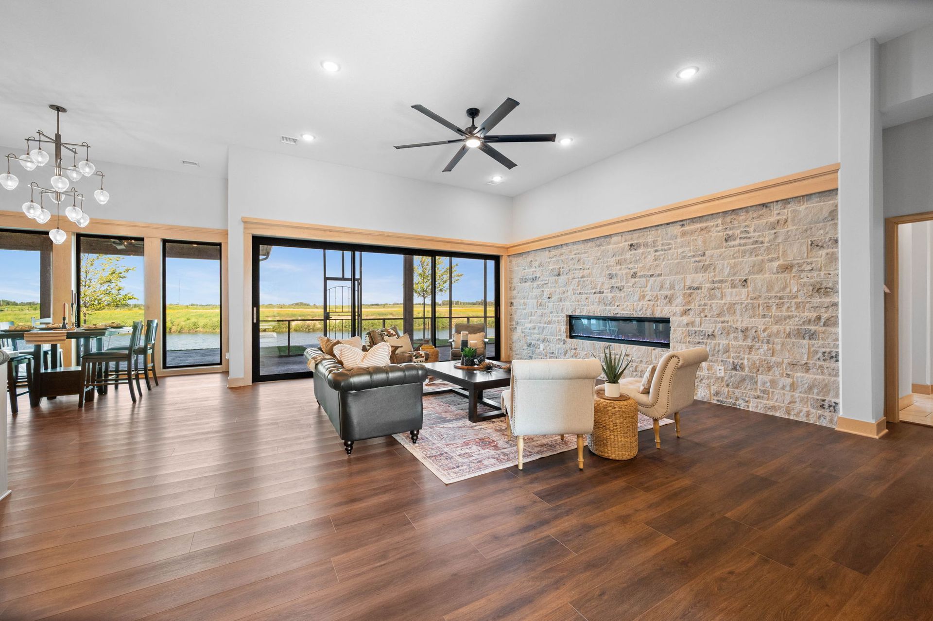 A living room filled with furniture and a ceiling fan.