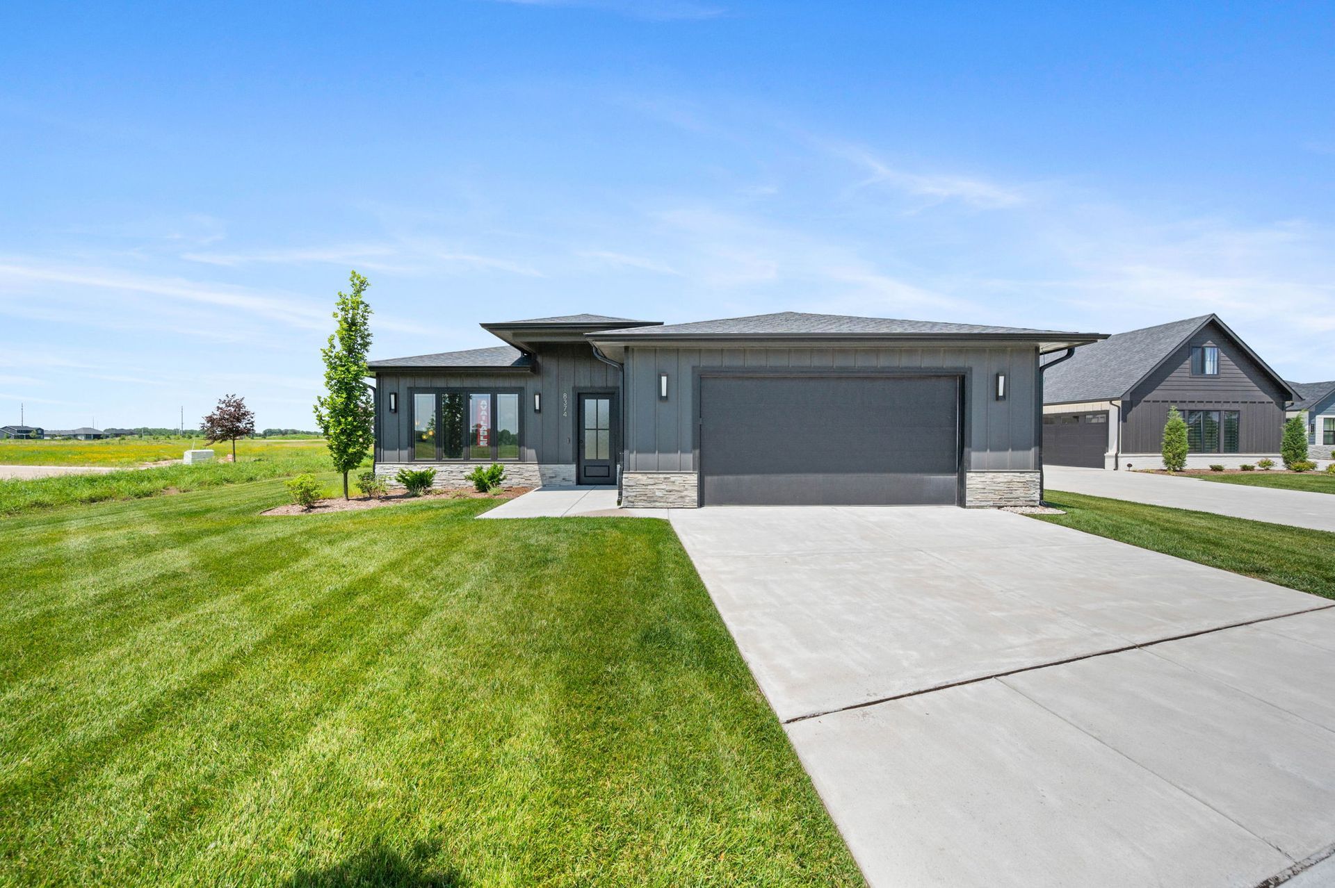 A house with a gray garage door.