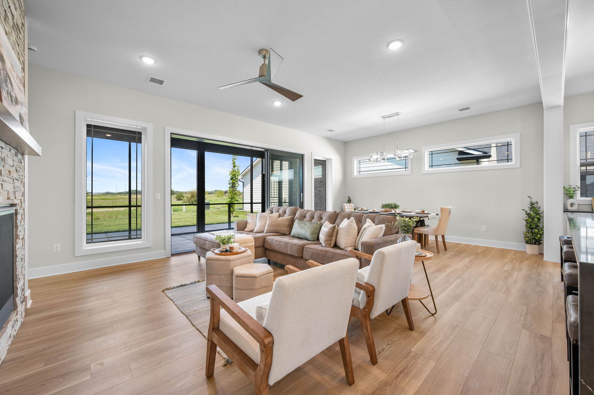 A living room filled with furniture and a ceiling fan.