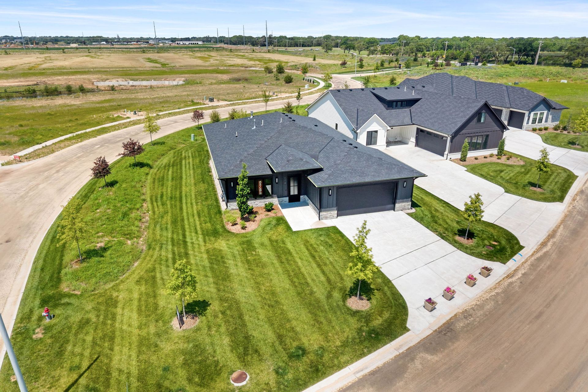 An aerial view of a large house with a lush green lawn.
