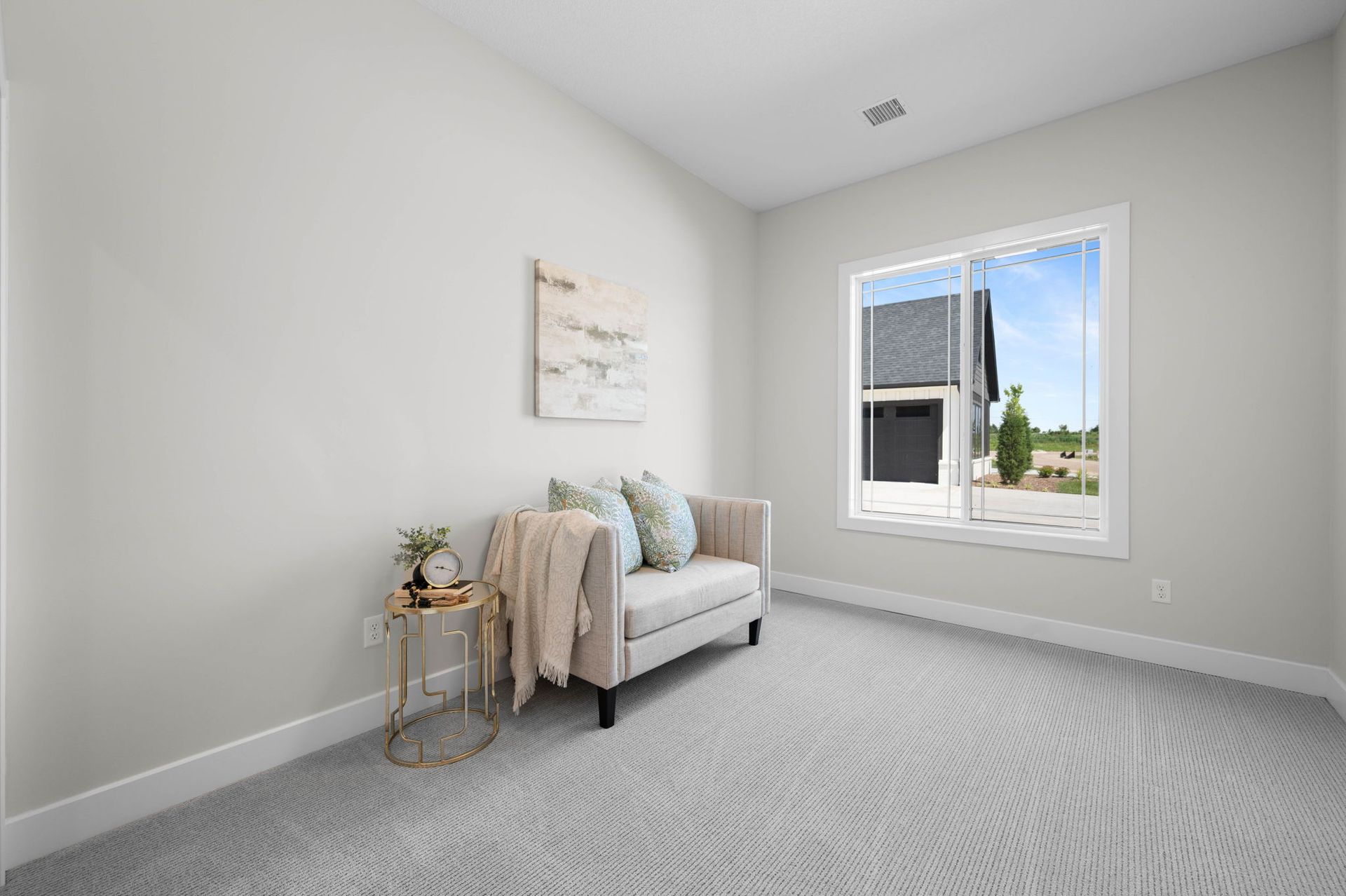 An empty room with a couch and a window.