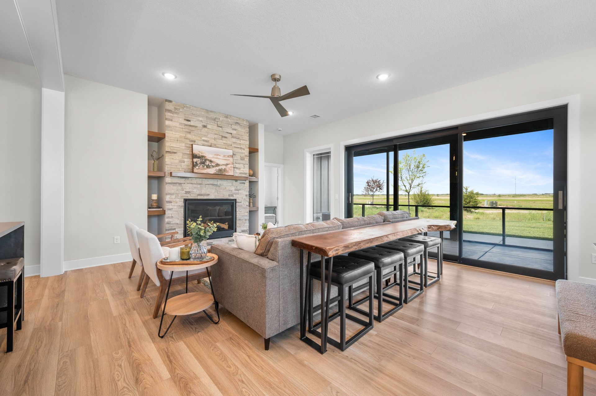 A living room with a couch, table, chairs, and a fireplace.