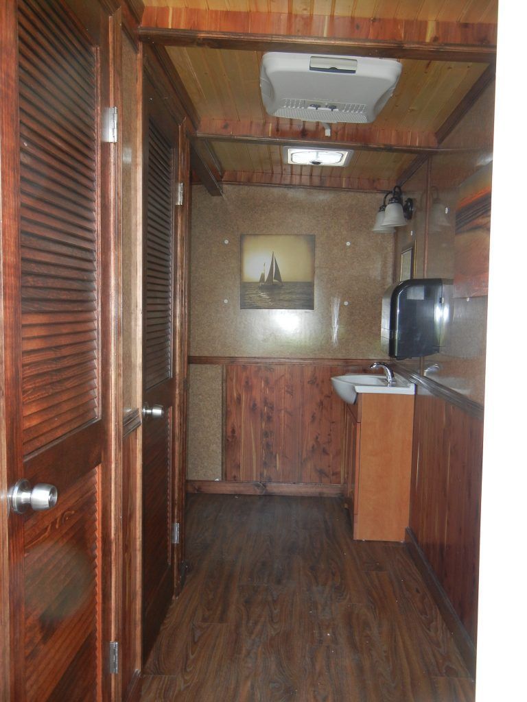 a hallway with a sink and a picture on the wall