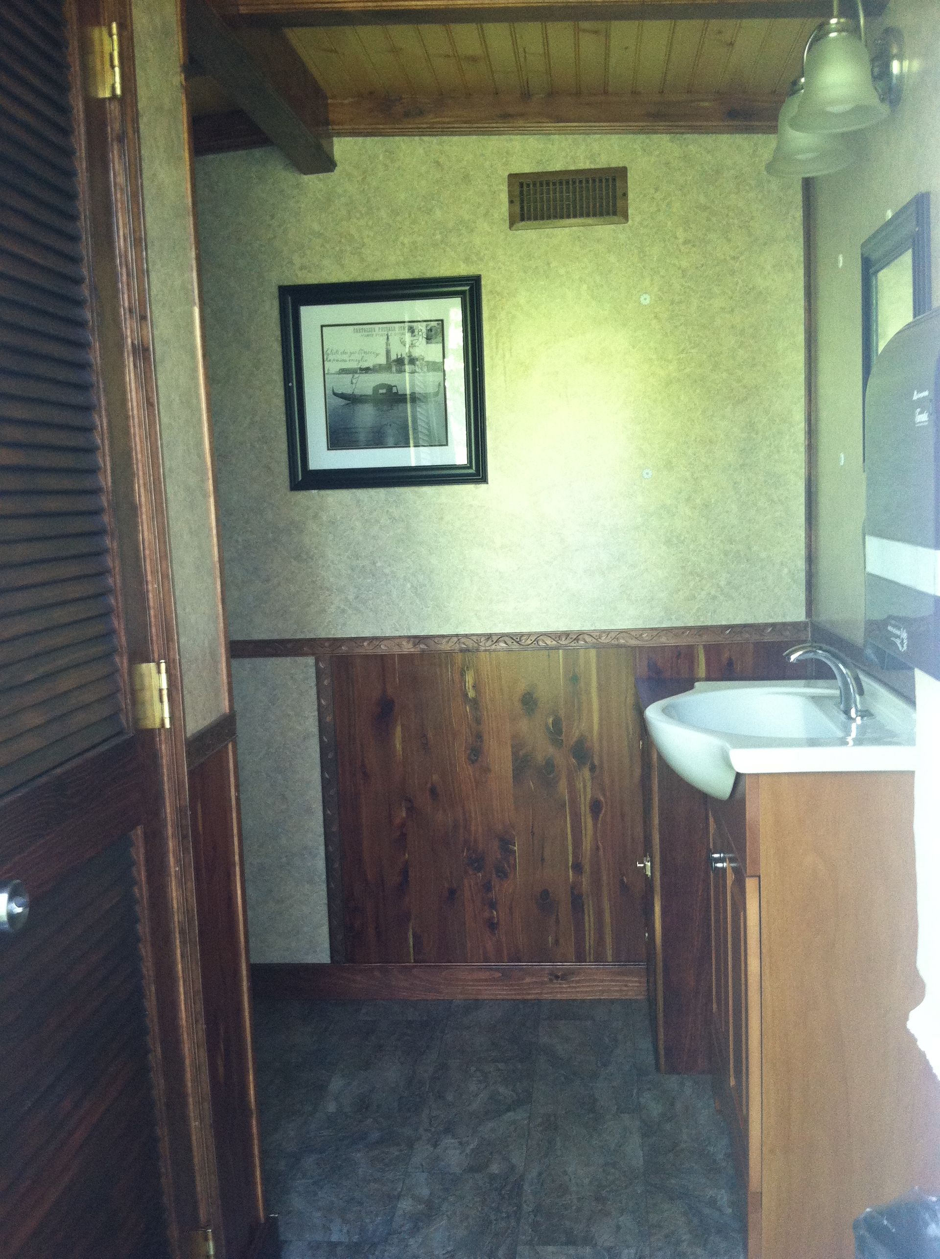 a bathroom with a sink and a picture on the wall