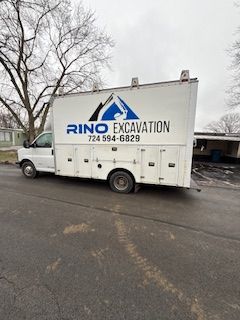 A white truck is parked on the side of the road.