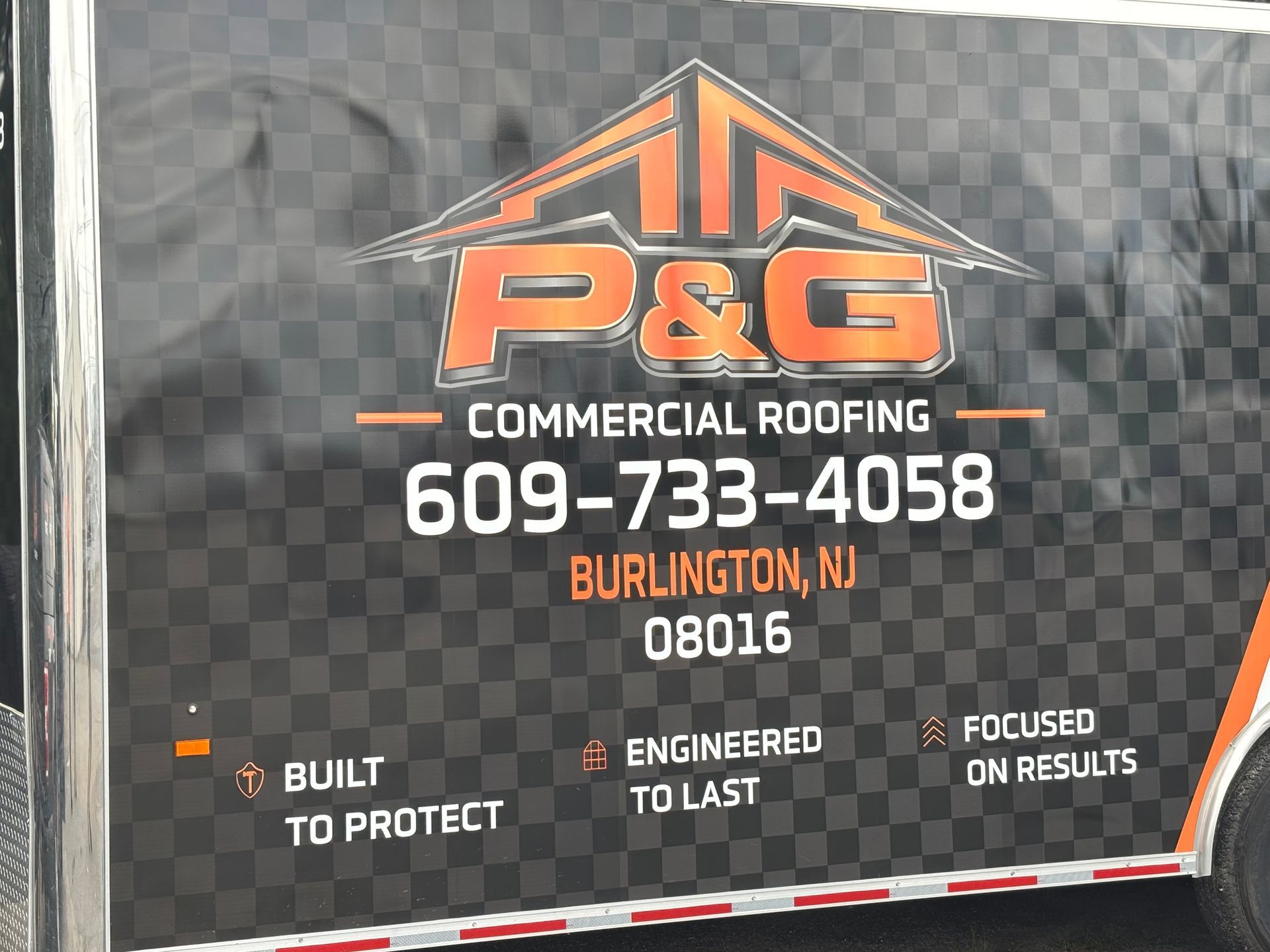 P&G Commercial Roofing truck sign with phone number, Burlington, NJ 08016, and slogan “Built to Protect”