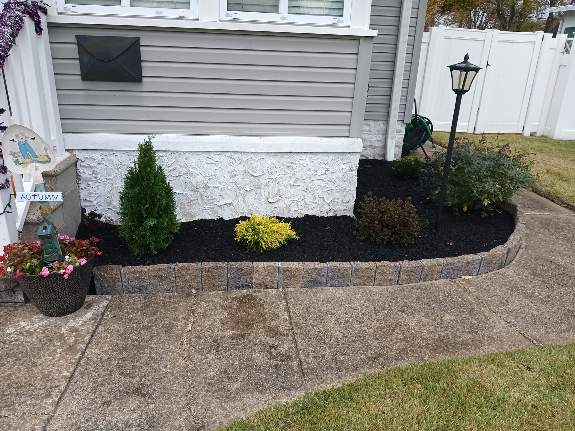 There is a mailbox on the side of the house.