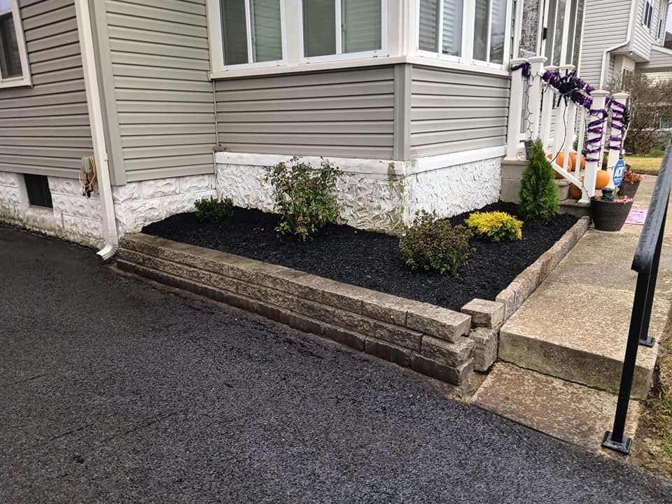 A house with a lush green garden in front of it.