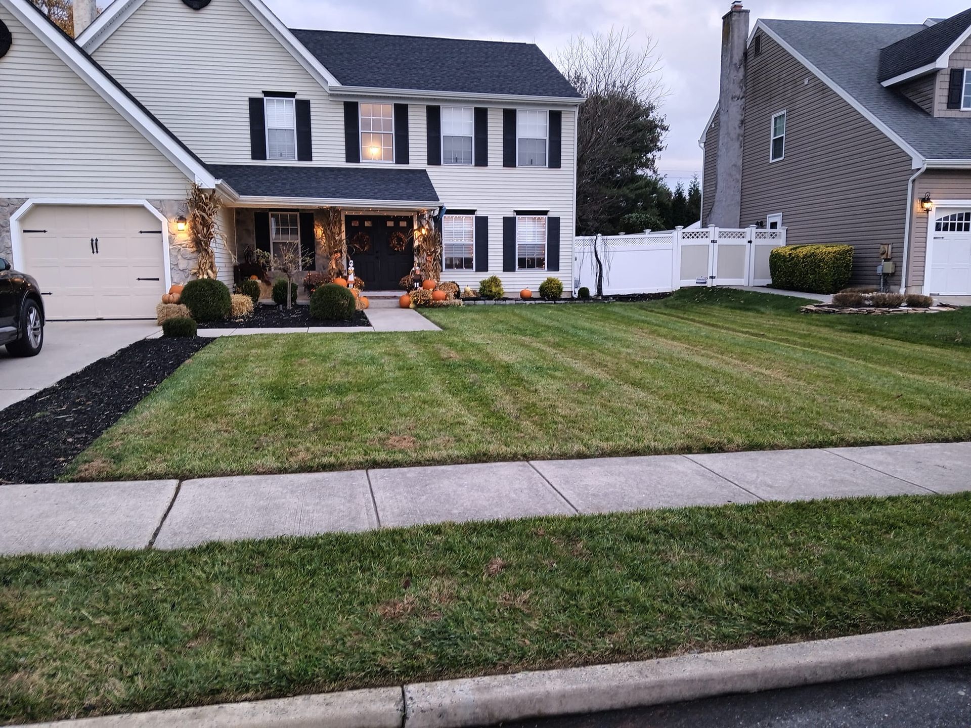 A house with a lush green lawn in front of it