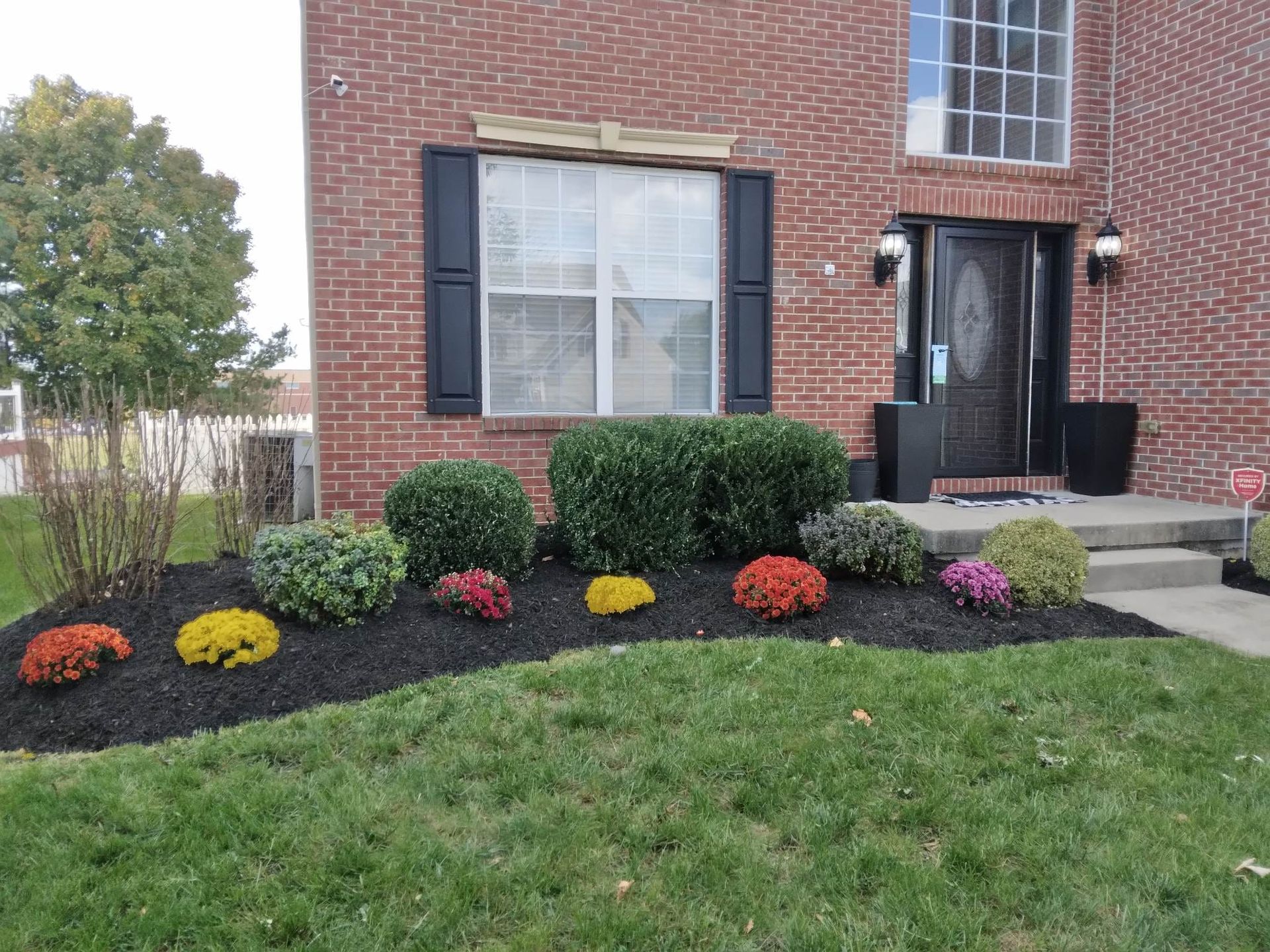 A brick house with flowers in front of it