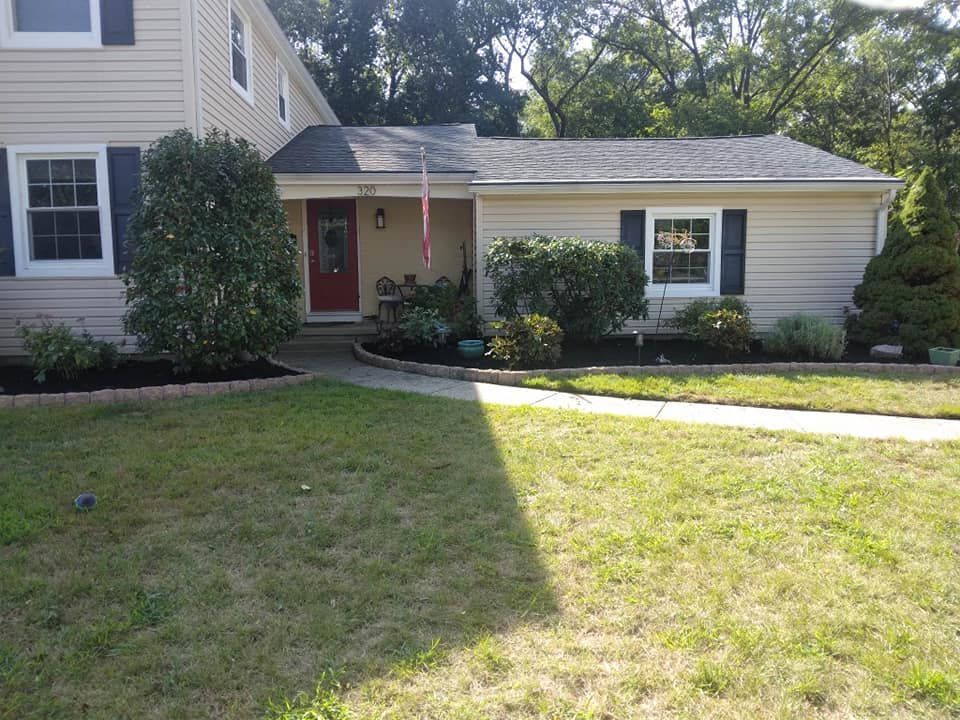 A house with a large lawn in front of it