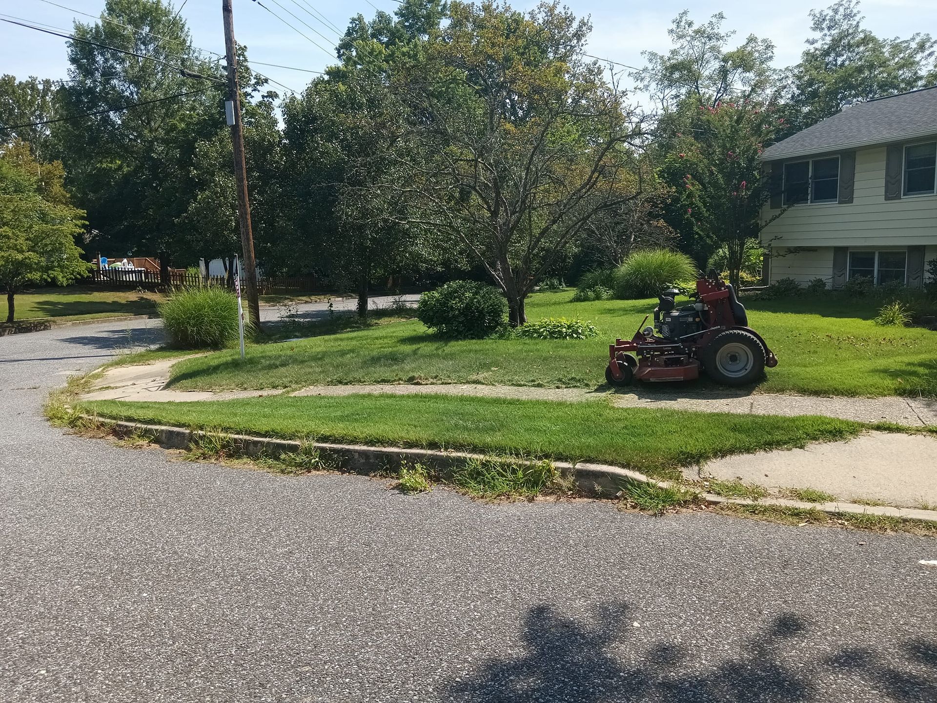 A lawn mower is parked in front of a house