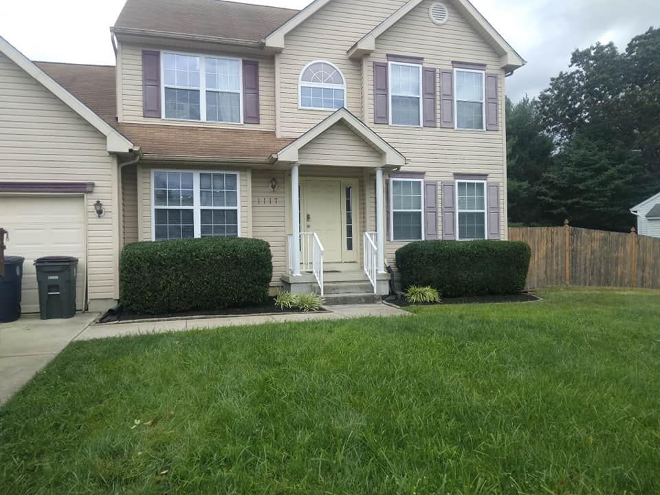 A large house with a large lawn in front of it.