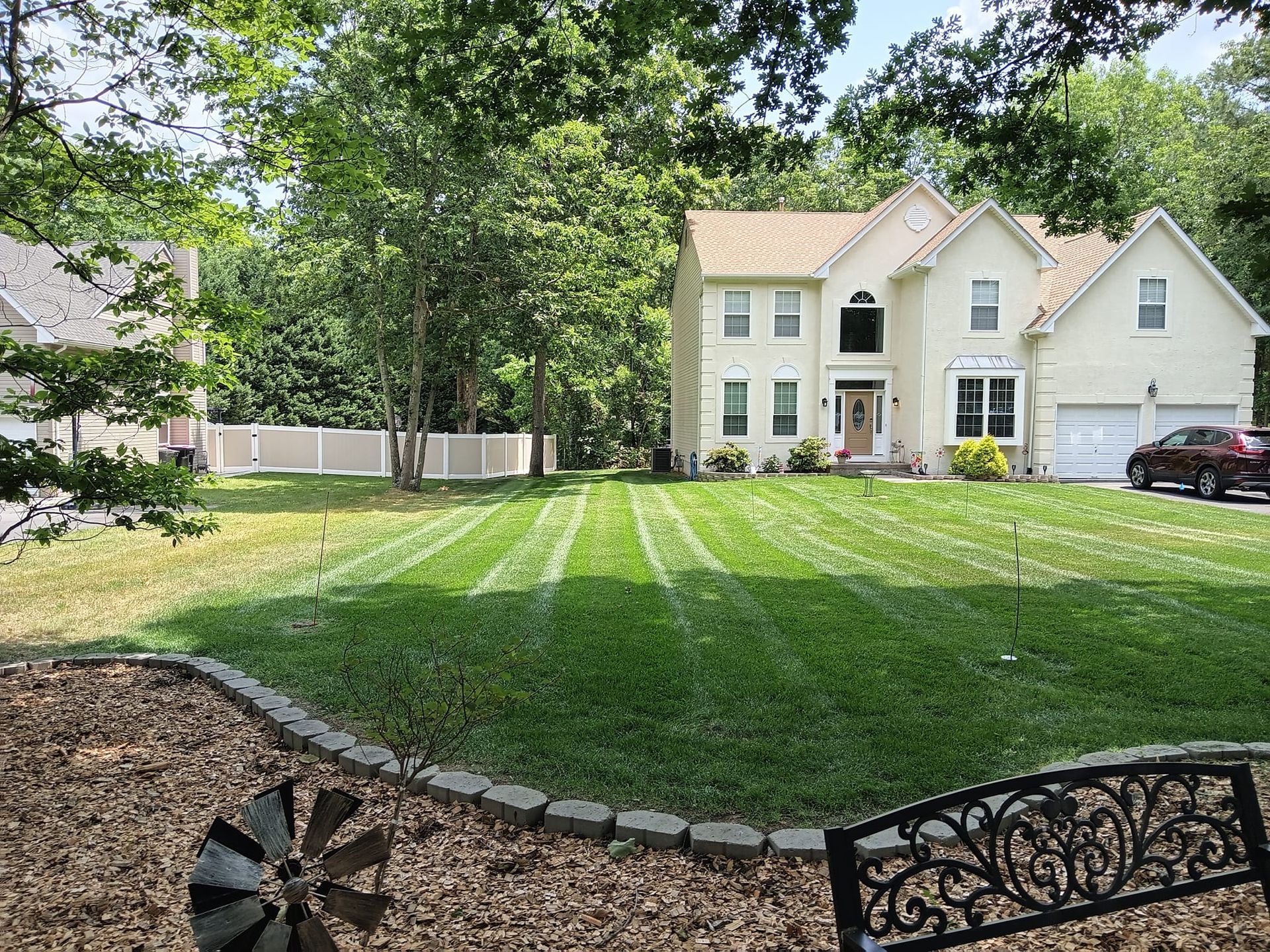 A large white house with a lush green lawn in front of it.