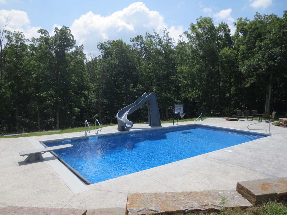 A large swimming pool with a slide in the middle