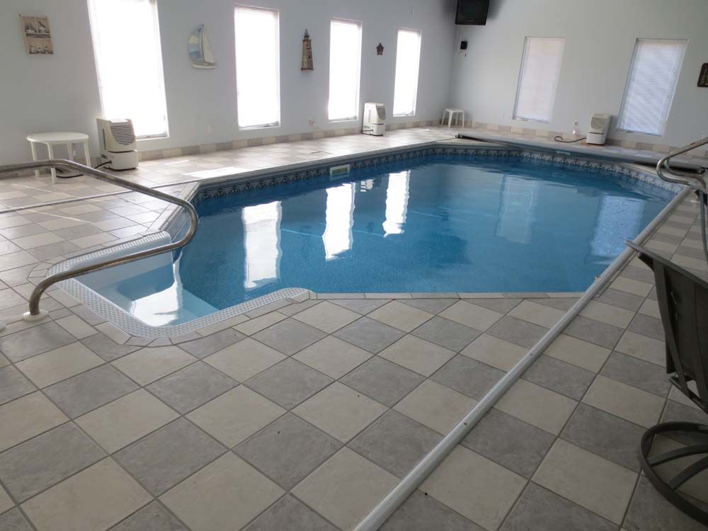 A large indoor swimming pool with a checkered floor