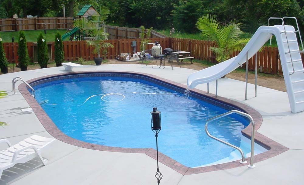 A large swimming pool with a slide attached to it
