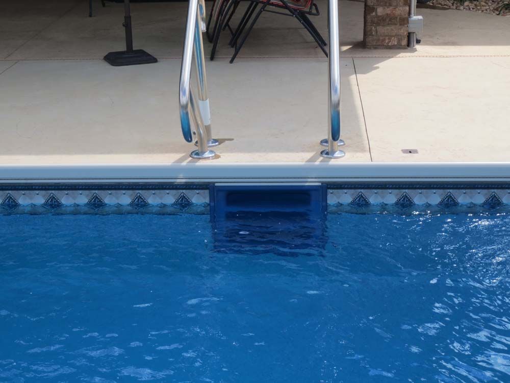 A swimming pool with stairs leading up to it