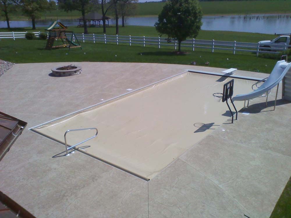A swimming pool with a slide and a fire pit