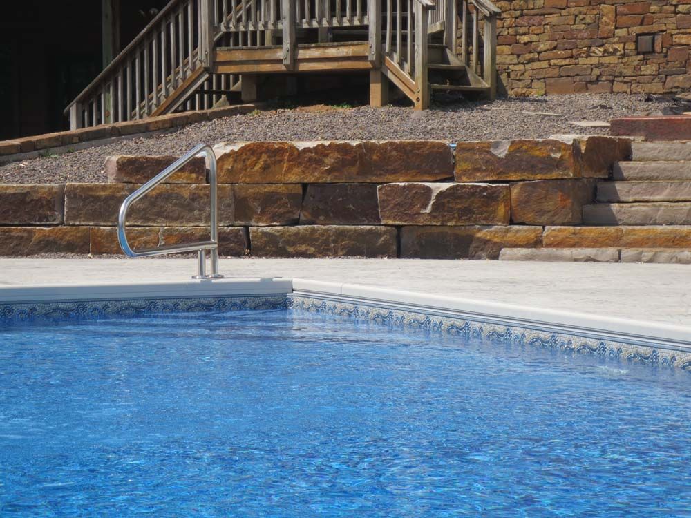 A large swimming pool with stairs leading up to it