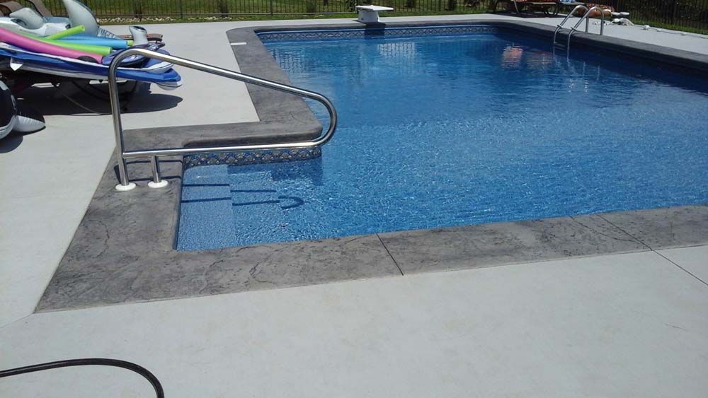 A large swimming pool with stairs leading to it