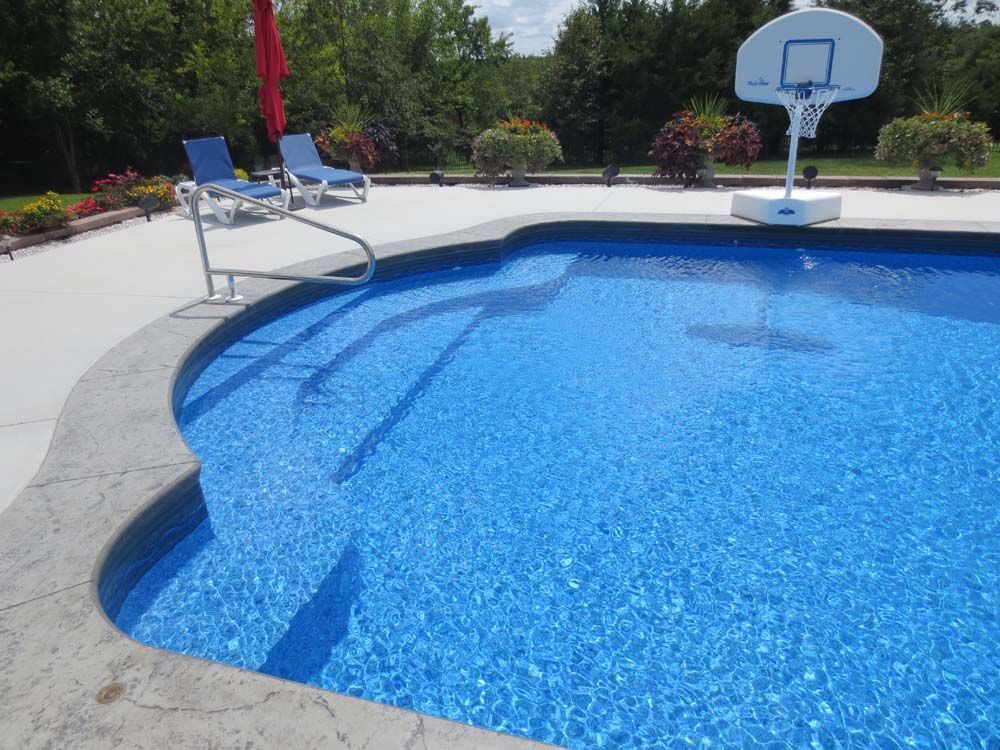 A swimming pool with a basketball hoop in it