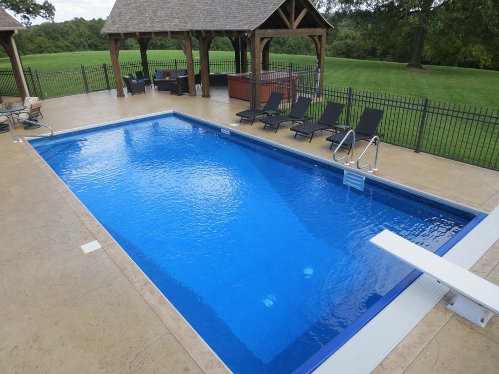 A large swimming pool with a diving board in the middle