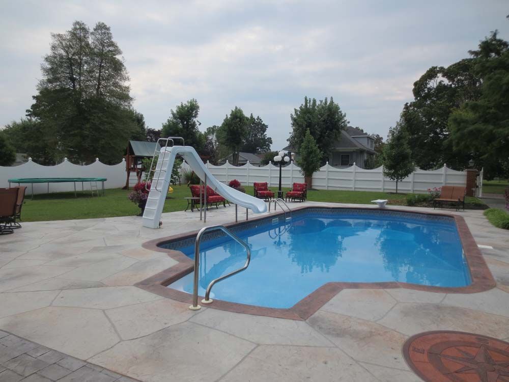 A large swimming pool with a slide attached to it