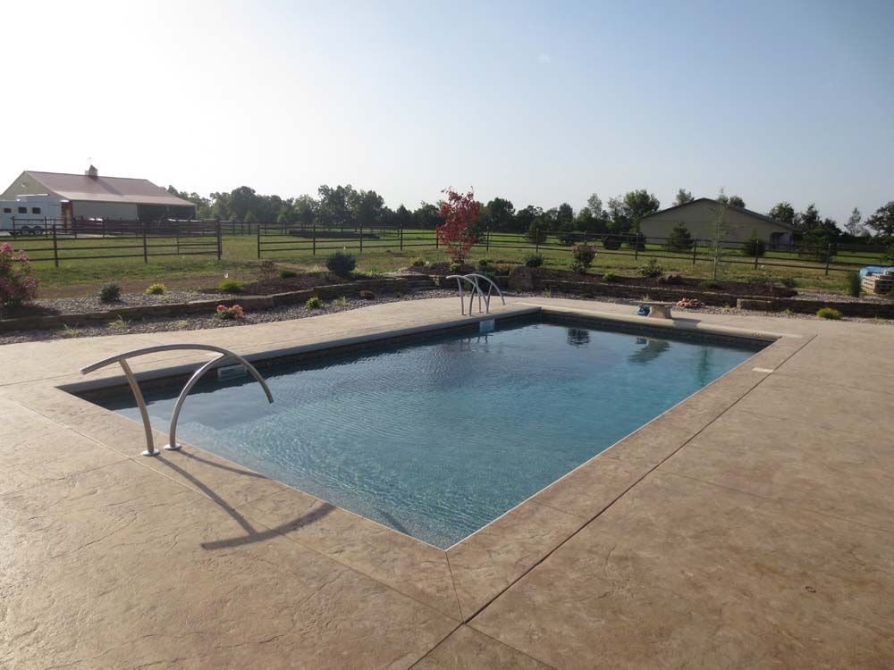 A large swimming pool with a staircase leading to it