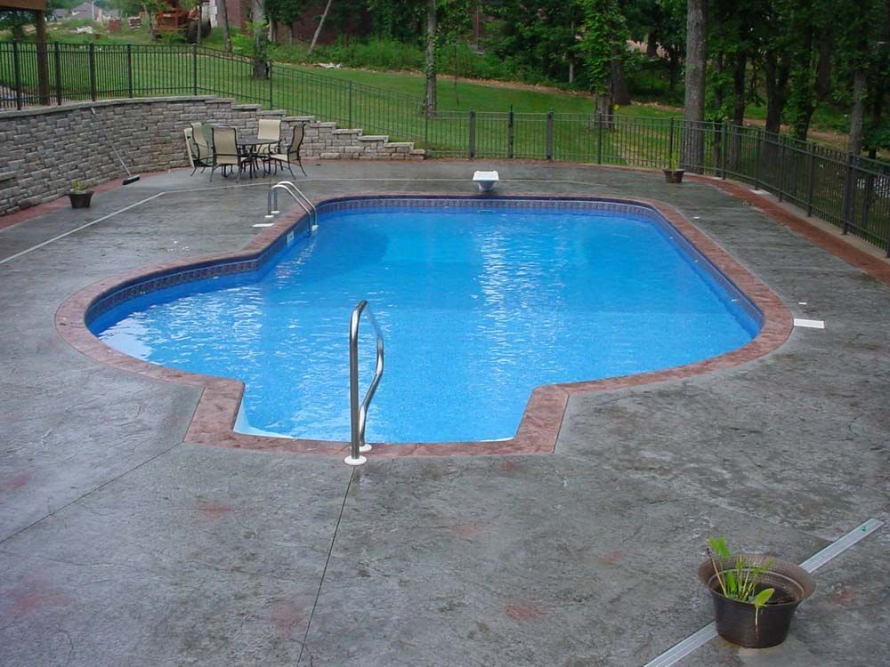 A large swimming pool with a staircase leading to it