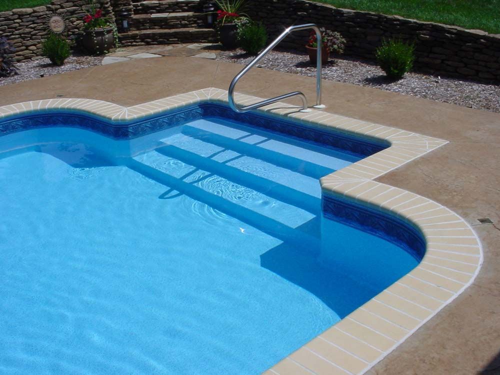 A swimming pool with stairs leading up to it
