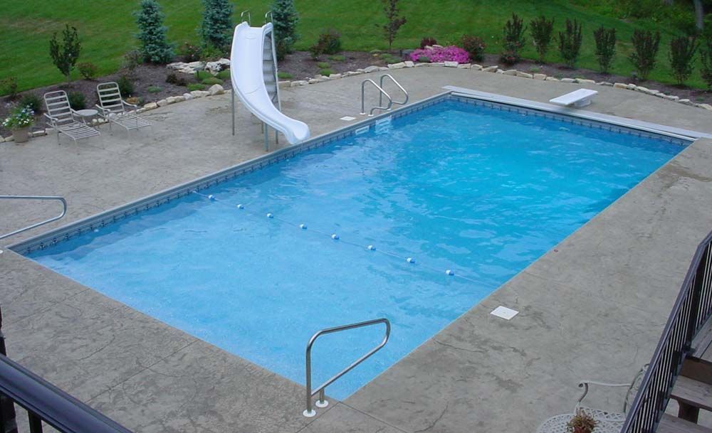 A large swimming pool with a slide attached to it