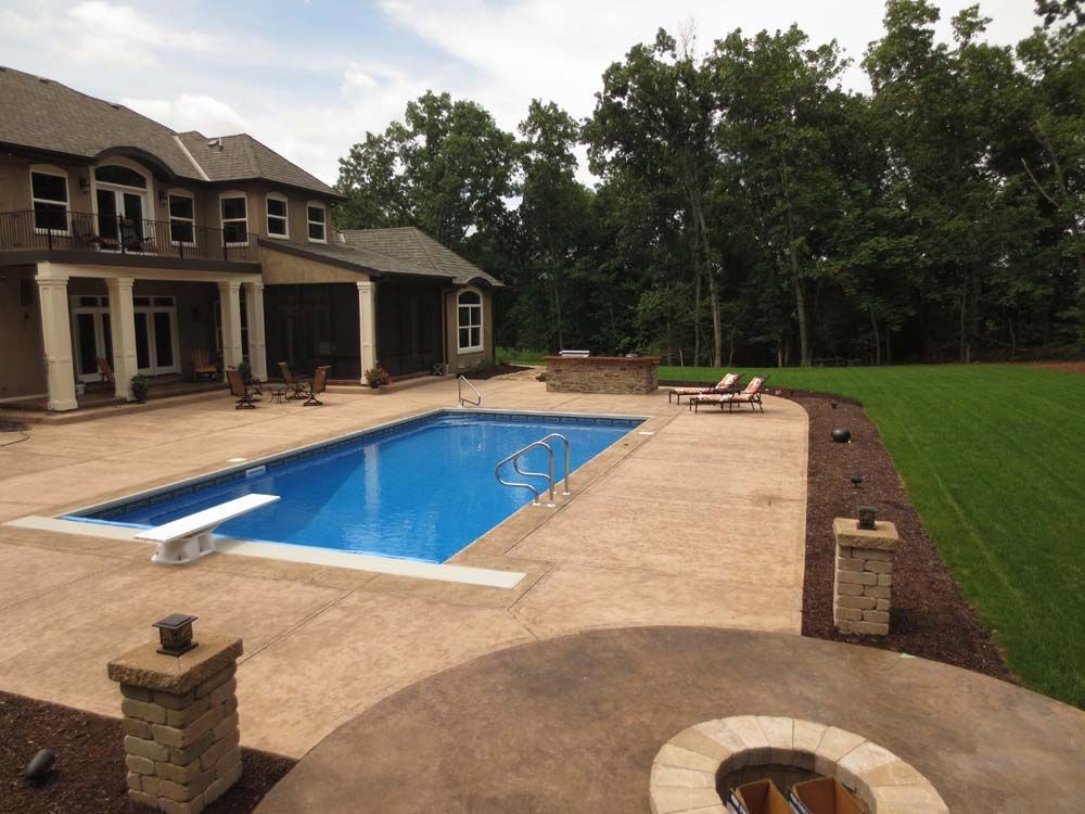 A large house with a large swimming pool in front of it