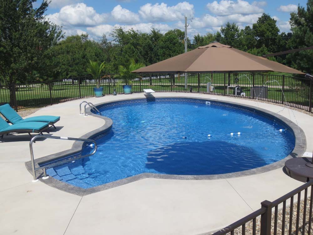 A large swimming pool with a gazebo in the background