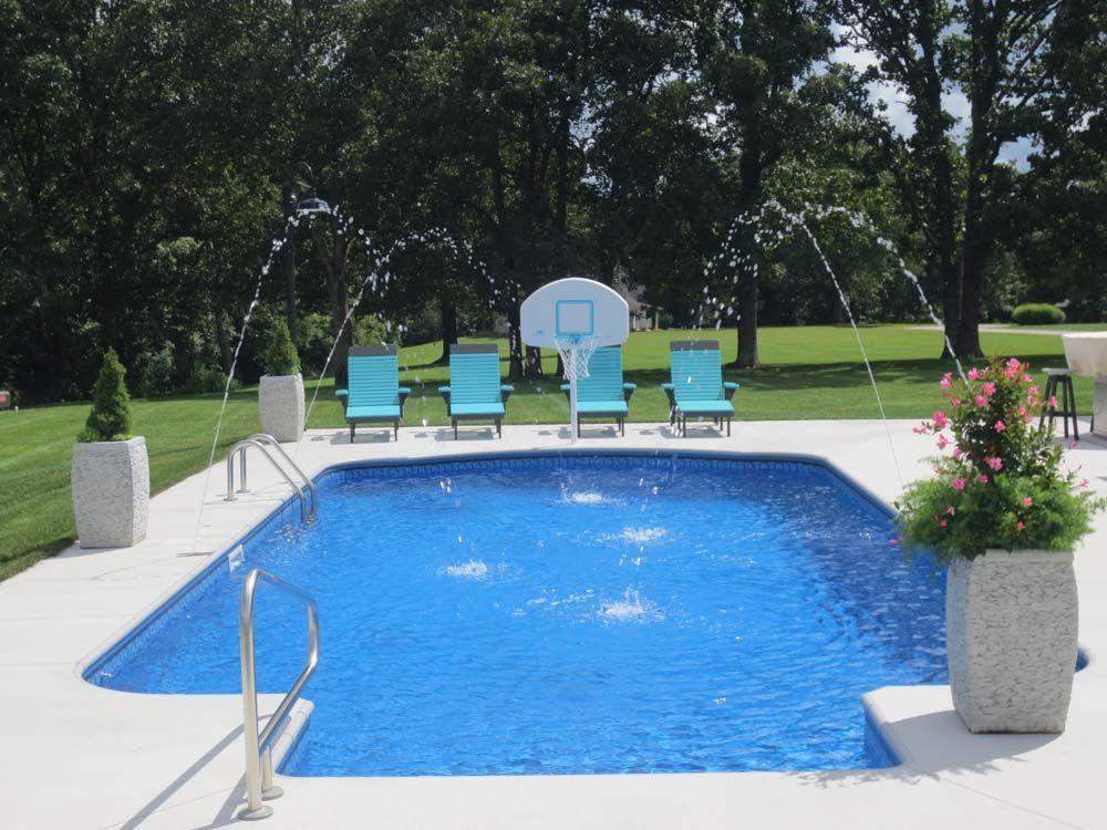A large swimming pool with a basketball hoop in the background
