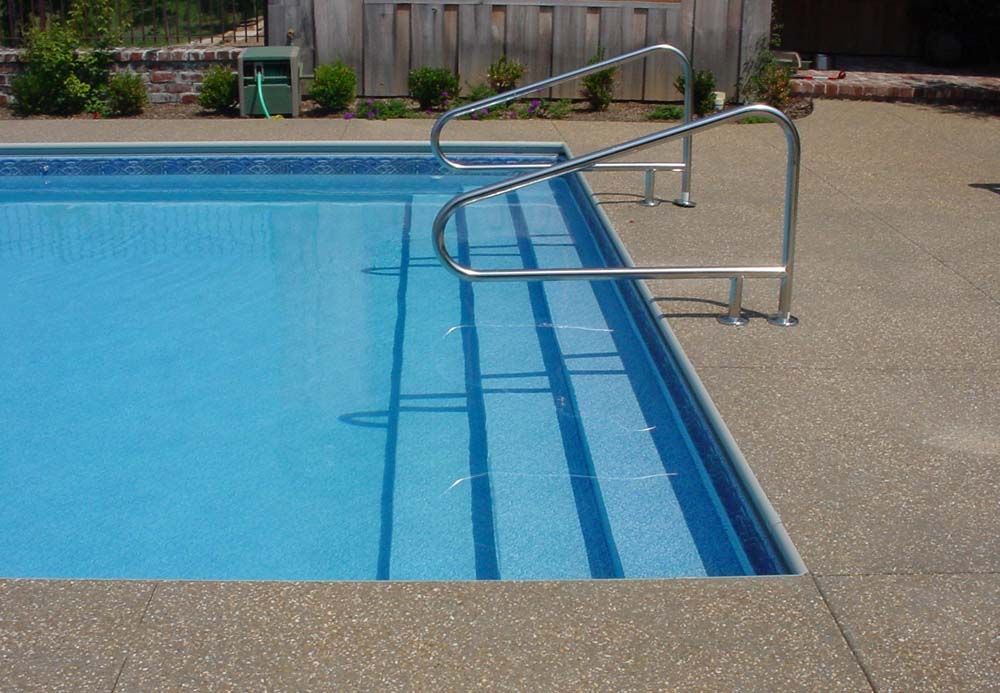 A swimming pool with stairs leading up to it