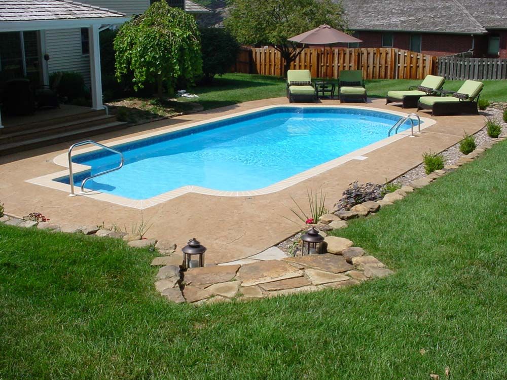 A large swimming pool in the backyard of a house