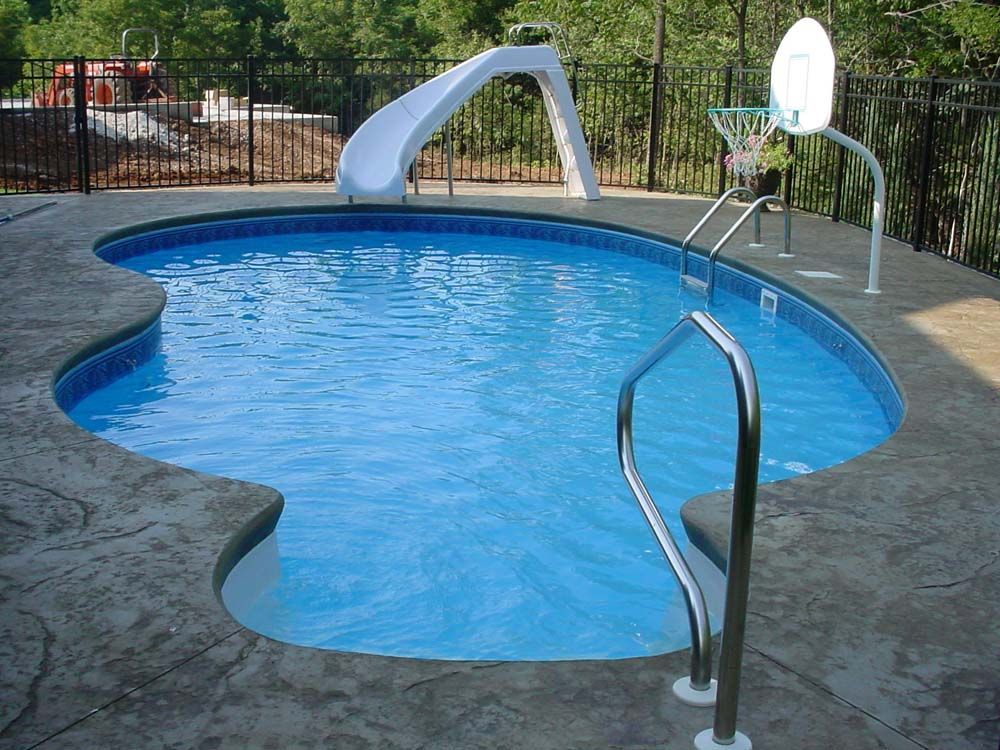 A swimming pool with a slide and a basketball hoop