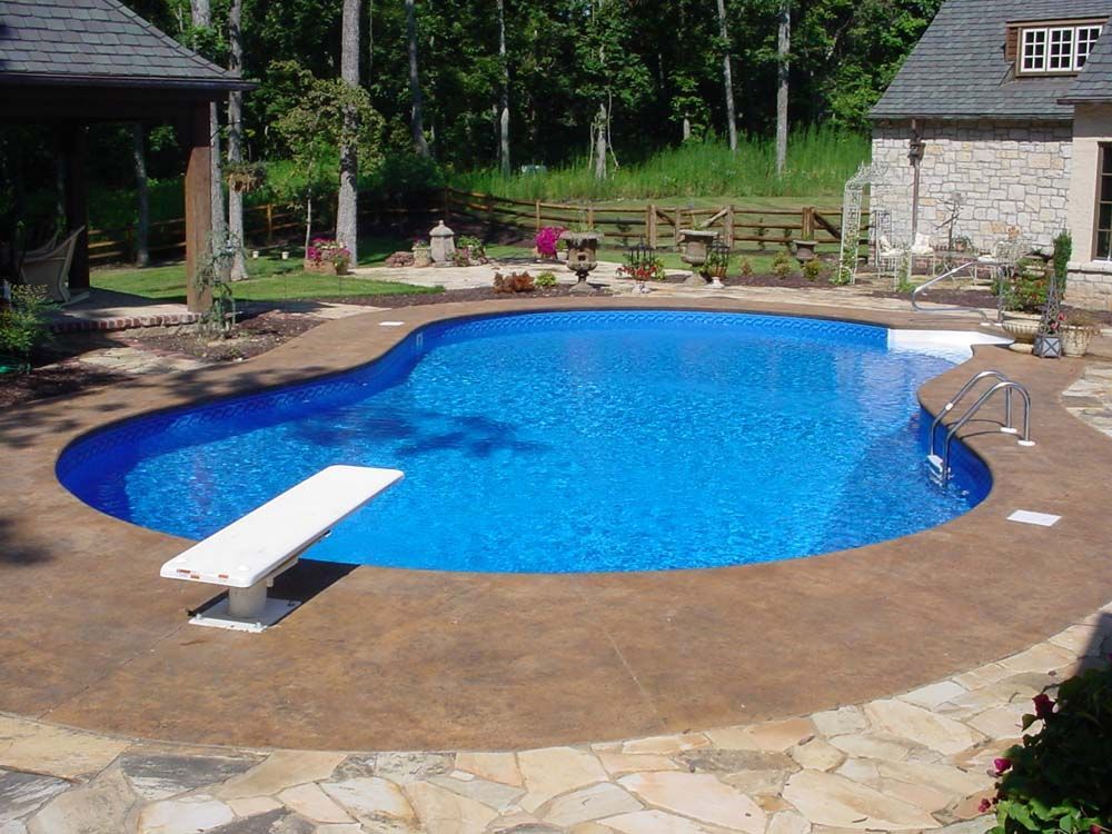 A large swimming pool with a diving board in the middle