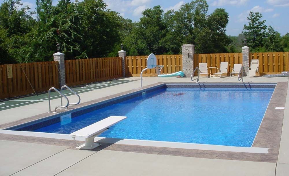 A large swimming pool with a diving board in the middle