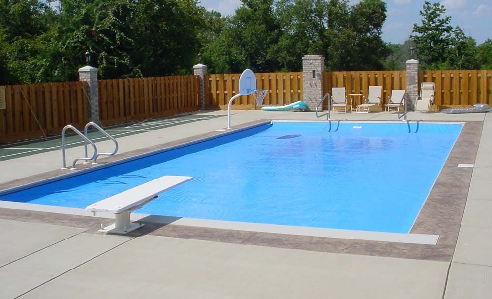 A large swimming pool with a diving board in the middle